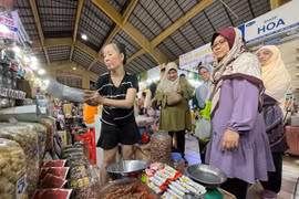 Turistas musulmanes visitan y compran especialidades vietnamitas en el mercado Ben Thanh, en Ciudad Ho Chi Minh. (Foto: https://www.sggp.org.vn/)