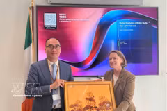 El viceauditor general de la Auditoría Estatal de Vietnam Bui Quoc Dung y la secretaria general de la Oficina del Auditor y Contralor General de Irlanda, Colette Drinan, intercambian regalos (Foto: VNA)