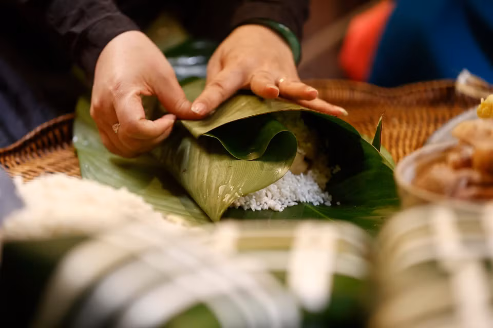 Se requiere de un par de manos habilidosas para envolver hermosos pasteles cuadrados en preparación para la tradicional festividad del Tet. (Foto: VNA)