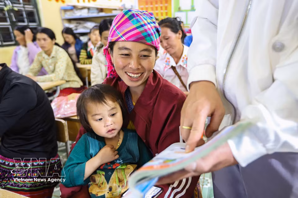 La alumna Hang Thi Cha lee siguiendo las indicaciones del maestro en el libro de texto de idioma vietnamita de primer grado. (Foto: VNA)