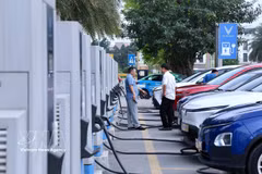 Varias personas cargan sus vehículos eléctricos en una estación de carga en el oeste de Hanoi. (Foto ilustrativa: VNA)