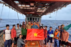 Las fuerzas de seguridad marítima de Ciudad Ho Chi Minh entregan la bandera nacional y difunden medidas preventivas contra la IUU a los pescadores (Foto: VNA)