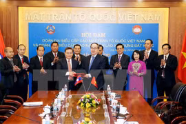 Organizaciones de masas de Vietnam y Laos robustecen cooperación