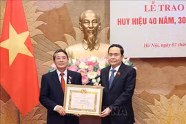 El presidente parlamentario Tran Thanh Man (derecha) entrega la insignia por 40 años de membresía del PCV a Nguyen Duc Hai, miembro del Comité Central del Partido y miembro del Comité de asuntos partidistas de la AN y vicepresidente del Parlamento. (Fuente:VNA)