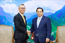 El primer ministro de Vietnam, Pham Minh Chinh (derecha), recibe al ministro de Inversión, Comercio e Industria de Malasia, Zafrul Abdul Aziz. (Foto: VNA)