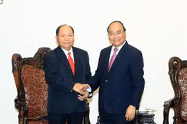 El primer ministro vietnamita, Nguyen Xuan Phuc, (D) y el ministro de Asuntos Internos de Laos, Khamman Sounvileuth
