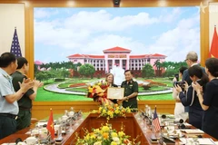 El viceministro Hoang Xuan Chien entrega certificados de reconocimiento a Aler Grubbs por sus destacadas contribuciones en la remediación del agente naranja/dioxina en Vietnam (Fuente: VNA)