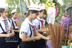 Estudiantes ofrecen incienso en memoria de los fallecidos. Foto: Dinh Huong – VNA
