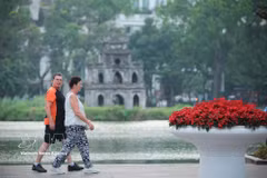 Los turistas pasean alrededor del lago Hoan Kiem, disfrutando de los espacios verdes y el paisaje característico de la capital (Fuente: VNA)