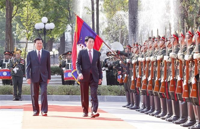 El presidente de Vietnam, Luong Cuong (derecha), y el secretario general del Comité Central del Partido Popular Revolucionario Lao (PLRP) y presidente de Laos, Thongloun Sisoulith, pasan revista a la guardia de honor en la ceremonia de bienvenida (Foto: VNA)