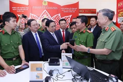 El primer ministro de Vietnam, Pham Minh Chinh, visita un pabellón de productos tecnológicos de transformación digital del Ministerio de Defensa (Foto: VNA)