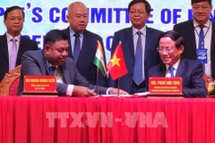 Representantes del Comité Popular de la provincia Binh Dinh y el Consulado General de la India en Ciudad Ho Chi Minh firman un memorando de entendimiento en la conferencia. (Foto: VNA)