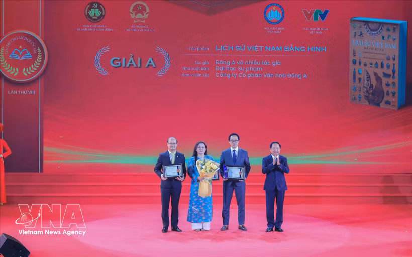 El miembro del Buró Político y jefe de la Comisión de Propaganda, Educación y Movilización de Masas del Comité Central del Partido Comunista de Vietnam, Trinh Van Quyet, entrega el premio A a los galardonados. (Fuente: VNA)
