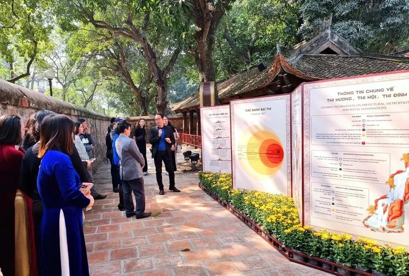 Los visitantes contemplan la exposición "Las estelas de piedra cuentan historias" (Fuente: Vietnam+) 