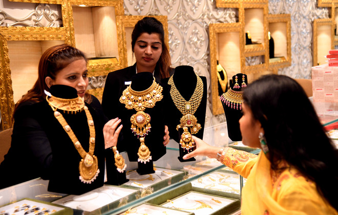 La gente compra joyas de oro en una tienda en Bhopal, la India. Fuente: Xinhua/VNA 10-su-kien-quoc-te-7.jpg