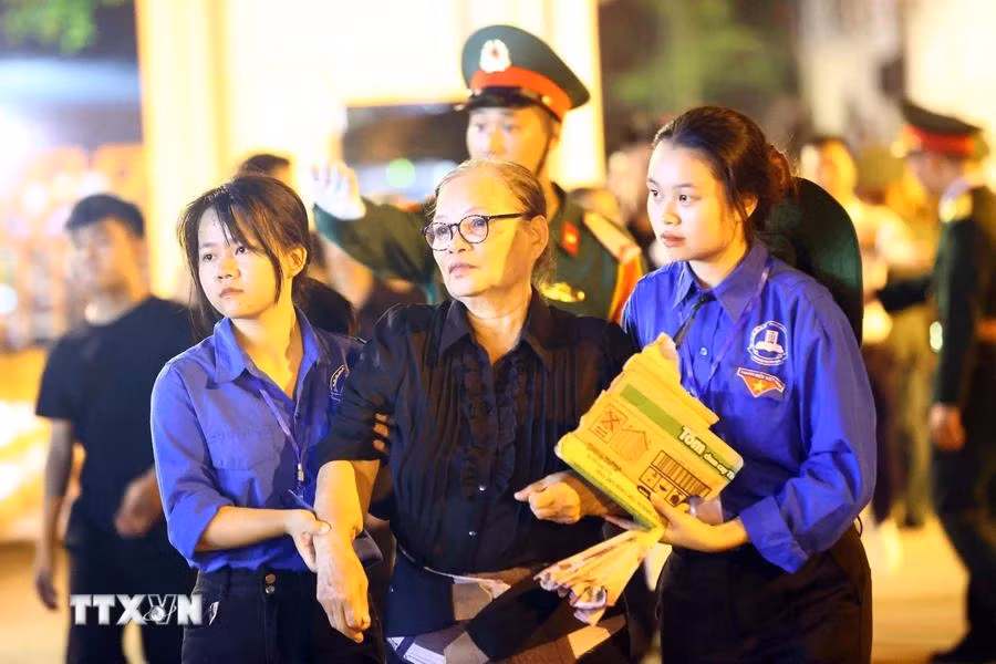 Una ciudadana fue apoyada por miembros de la Unión de Jóvenes Comunistas Ho Chi Minh para despedir al Secretario General. (Foto: VNA)