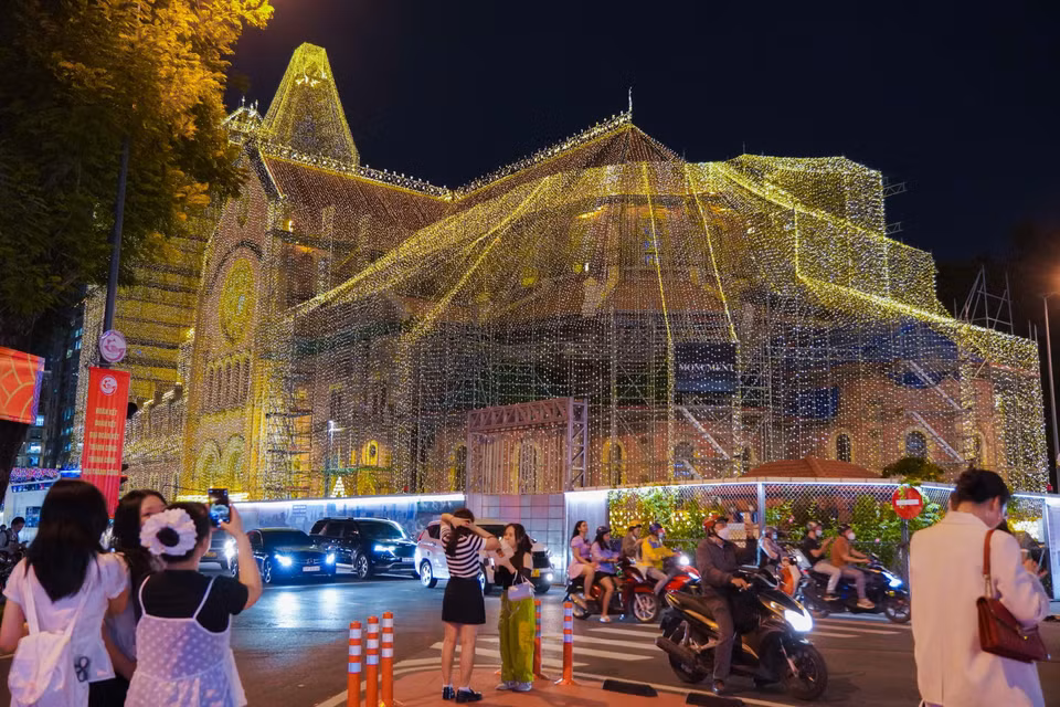 La Catedral Basílica de Notre Dame de Saigón brilla en el centro de Ciudad Ho Chi Minh, lo que entusiasma a muchas personas. (Foto: VNA)