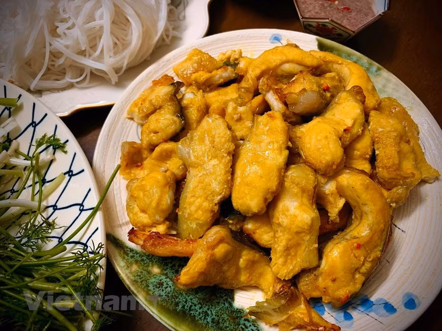 Sobre una bandeja con comino, cebolla, maní tostado, fideos y un bol de pasta de camarones fermentado. Cómo hacer pasta de camarones fermentado: poner pasta de camarones en un bol, agregar un poco de azúcar blanca, vino blanco, zumo de limón, batirlo y luego agregar el chile. O poner un poco de aceite de cocina en una sartén, verter la pasta de camarones y un poco de vino y cocinar, agregar un poco de azúcar para disolver, pasta de camarones al limón recién exprimida y agregar el chile, sazonar al gusto. El pescado después de ser asado a la parrilla en una freidora de 180 grados durante 10 minutos por lado o puede ser asado con carbón también es muy delicioso. 