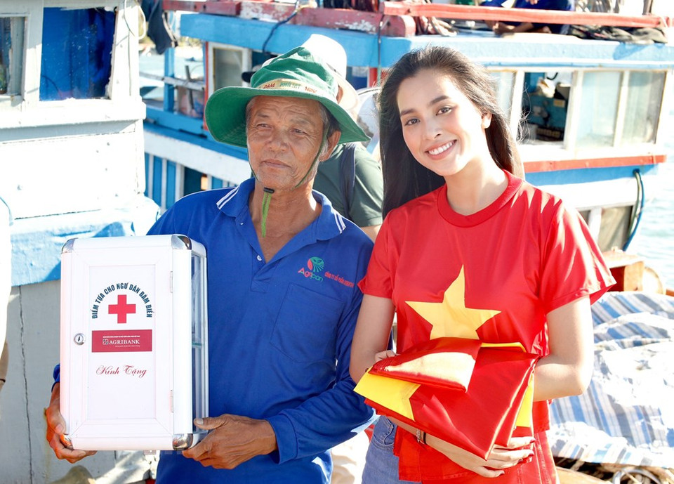La miss Tieu Vi presentó la bandera nacional al capitán de un barco. (Foto: Vietnam +)