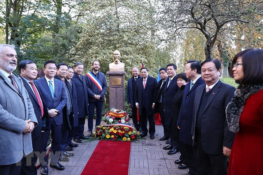 El primer ministro Pham Minh Chinh y la delegación vietnamita de alto rango depositan ofrendas florales ante el busto del Presidente Ho Chi Minh en el parque Montreau (Foto: VNA)