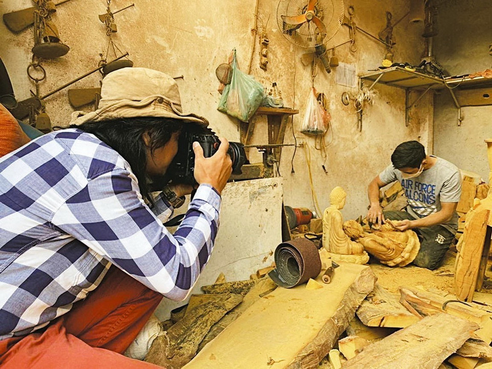 El reportero An Thanh Dat en el pueblo artesanal de Son Dong, Hoai Duc, Hanoi, diciembre de 2022. (Foto: VNA)