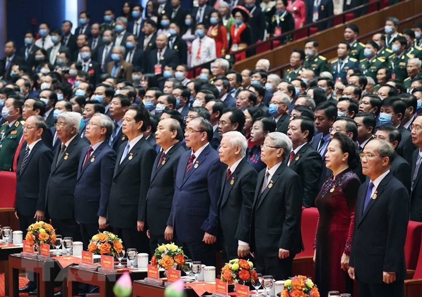 Dirigentes y exdirigentes de Vietnam realizan el saludo a la bandera nacional. (Fuente: VNA)
