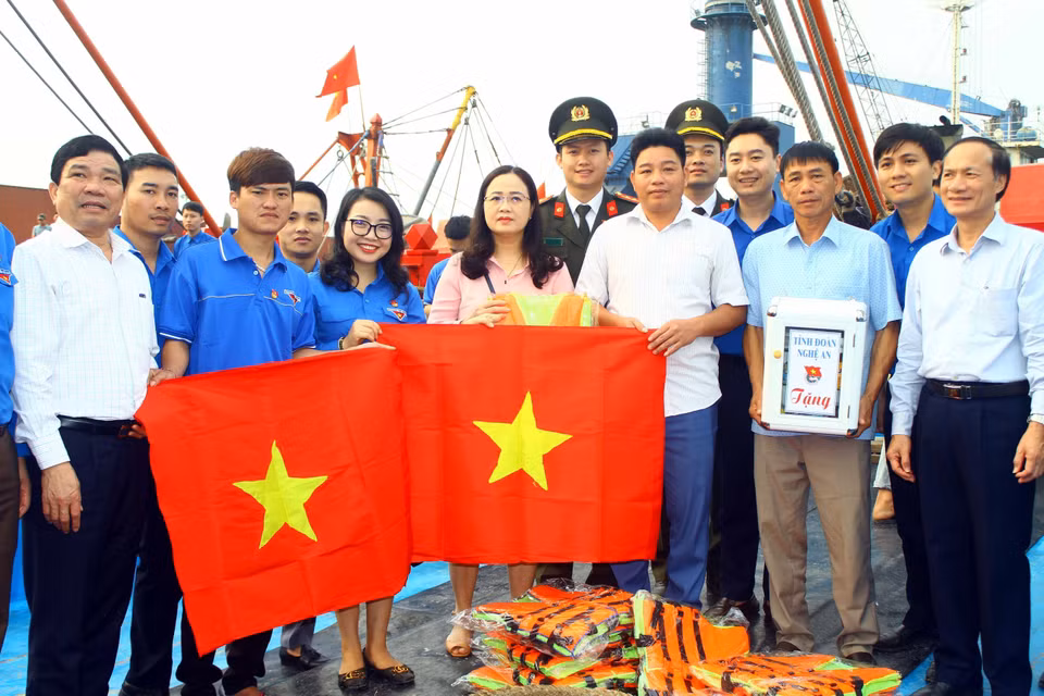 El Comité Permanente de la Unión juvenil de la provincia de Nghe An entrega las banderas nacionales a pescadores en un programa voluntario efectuado en los mares e islas en 2020 (Foto: VNA)
