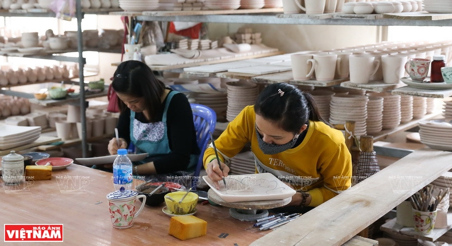 Los artistas trabajan de manera diligente con la decoración de cada producto. (Fuente: VNA)