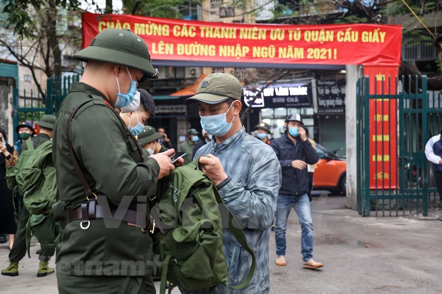 En el distrito Cau Giay de la capital Hanoi, un total de 71 jóvenes se alista en el ejército, de los cuales 21 jóvenes escribieron solicitudes por sí mismos para unirse a las fuerzas armadas. Los jóvenes alistados en este distrito en 2021 serán enviados a las siguientes unidades: La División de Infantería 301 bajo el Comando de la Capital de Hanoi, la División de Defensa Aérea 361 de la Fuerza de Defensa Aérea y la Seguridad Pública de Hanoi. El Ministerio de Defensa también ordena a las unidades preparar de modo activo las instalaciones para garantizar buenas condiciones de vida y entrenamiento para los reclutas. Todos deben estar listo antes de la llegada de los jóvenes y debe cumplir con las normas del ejército. (Foto: Vietnam+)