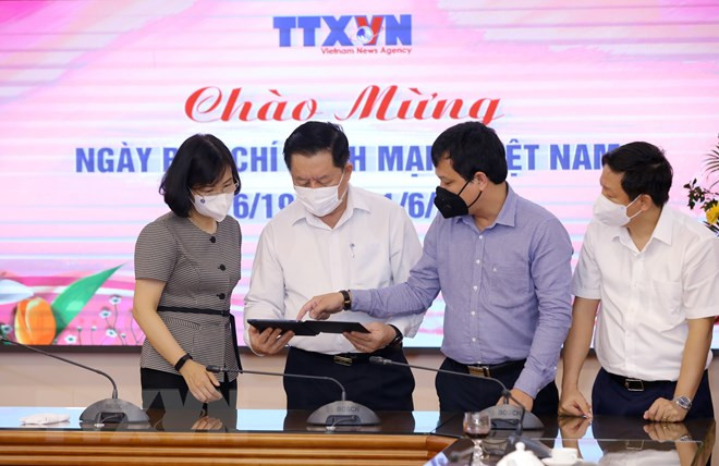 La subdirectora general de la VNA, Vu Viet Trang, presenta las publicaciones electrónicas de la agencia al secretario del Comité Central del Partido y jefe de su Comisión de Propaganda y Educación, Nguyen Trong Nghia (Foto: VNA)