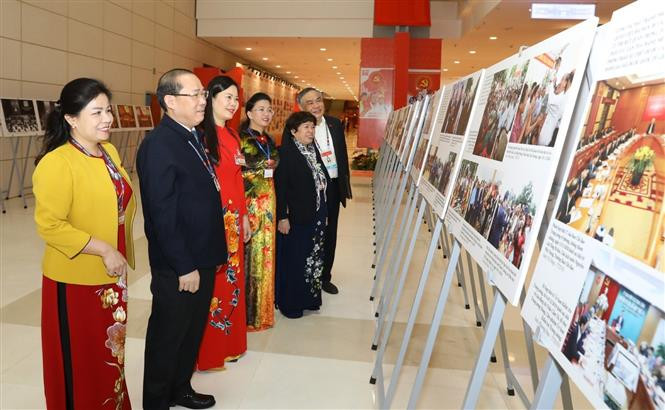 Los delegados visitan la exhibición fotográfica ¨Avanzar con paso firme bajo la bandera del Partido glorioso¨, organizada por la Agencia vietnamita de Noticias al servicio del XIII Congreso del Partido Comunista de Vietnam (Fuente: VNA)