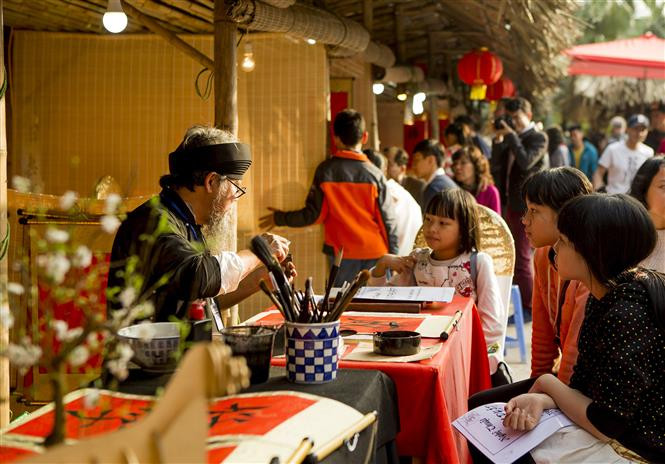 Tradición de pedir las letras de caligrafía a principios del año nuevo lunar en el lago Van del Templo de Literatura en Hanoi (Fuente: VNA)