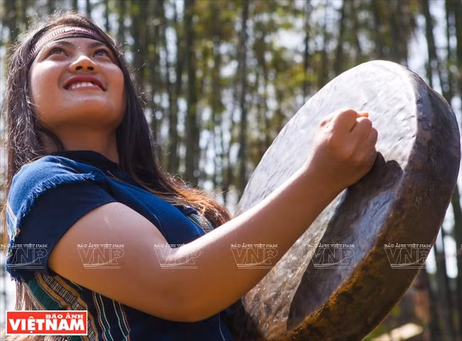 Muchacha del pueblo Xe Dang presenta el gong en un rito de la etnia Xe Dang. 