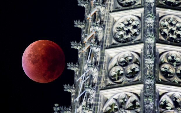La súper luna apareció rojizo al lado de una torre de la Catedral de Colonia, Alemania (Fuente: EPA)