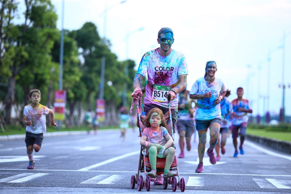 Un padre y su hija sentada en un carrito (Fuente: VNA)