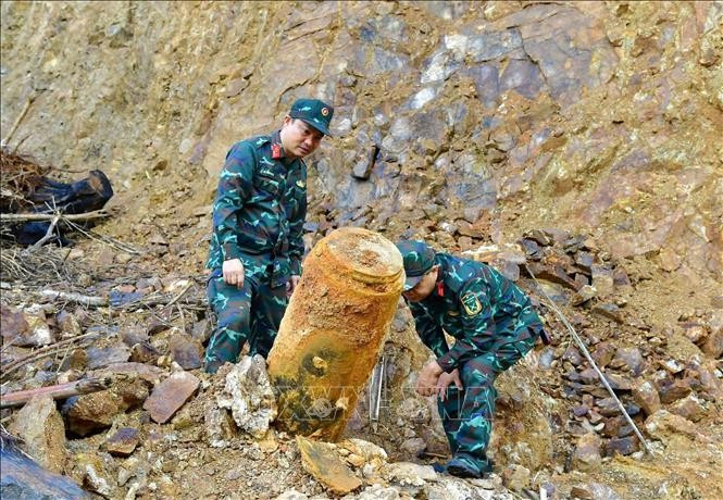 Las autoridades trasladan la bomba al lugar de la detonación. (Foto: VNA)