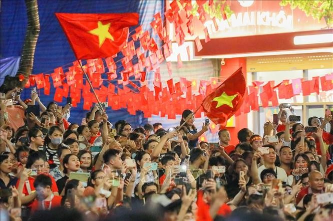 Los hanoiyense dan la bienvenida a los bloques que transitan por la calle Trang Tien durante el ensayo estatal del desfile y la marcha del evento A80. Foto: VNA