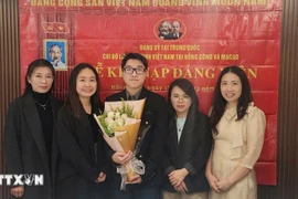 Nguyen Thi Xuan Hue (segunda desde la izquierda), estudiante de doctorado en Lingüística Inglesa Aplicada de la Universidad de Macao (China), en una ceremonia de admisión de nuevos miembros del partido. (Fuente: VNA)