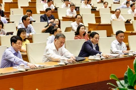El secretario general del Partido Comunista de Vietnam, el presidente Luong Cuong, el primer ministro Pham Minh Chinh y los delegados aprueban resoluciones y leyes. (Foto: VNA)