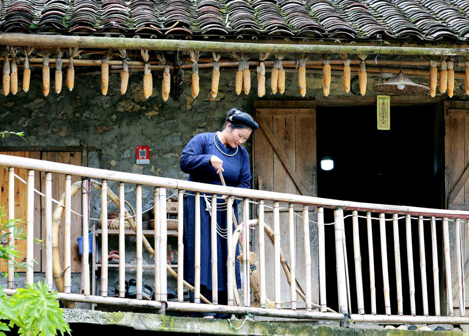 La habitante Mac Thi Khon se prepara para recibir a los huéspedes en la casa tradicional de su familia, renovada como alojamiento familiar, en el antiguo pueblo de piedra de Khuoi Ky, Trung Khanh. (Fuente:VNA)