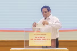 El primer ministro Pham Minh Chinh realiza una donación para ayudar a los pobladores a superar las consecuencias del tifón (Foto: VNA)