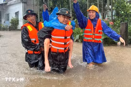 Fuerzas militares rescatan a un residente de una zona inundada. Foto: VNA