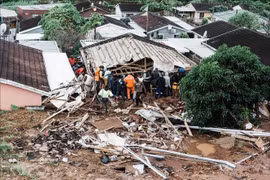 Búsqueda de víctimas atrapadas bajo una casa derrumbada tras las inundaciones en la ciudad de Durban, provincia de KwaZulu-Natal, Sudáfrica, el 12 de abril de 2022. (Foto: AFP/VNA)
