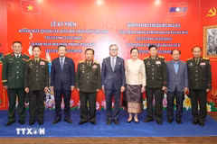 Los delegados de Vietnam y Laos en el evento (Fuente: VNA)